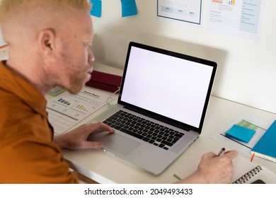 Albino african american man working from home using laptop with copy space. remote working using technology at home. - Powered by Shutterstock