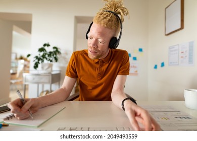 Albino african american man working from home making video call. remote working using technology at home. - Powered by Shutterstock