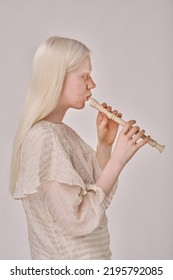 Albino Girl Playing On Flute