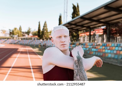 Albino Male Athlete Running Track Stretching, Champion