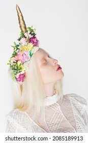 Albino Model In Wreath With Flowers Closing Eyes Isolated On White