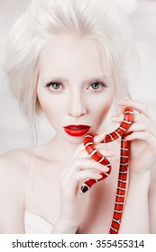 albino white woman with red lips and red snake beauty