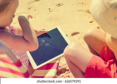 Albufeira, Portugal - 10 October, 2016: Child Holding In Hands Apple Ipad 2 Tablet Computer On Beach Outdoors Background. Vacation Relaxation Closeup Shot. Mobility E-reader, Smart Pad On Chair