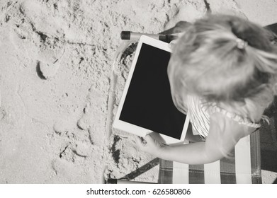 Albufeira, Portugal - 10 October, 2016: Child Holding In Hands Apple Ipad 2 Tablet Computer On Beach Outdoors Background. Vacation Relaxation Closeup Shot. Mobility E-reader, Smart Pad On Chair