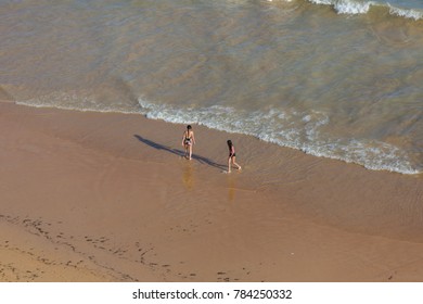 ALBUFEIRA, PORTUGAL - AUGUST 22, 2017: People at the famous beach of Praia da Felesia in Albufeira. This beach is a part of famous tourist region of Algarve.