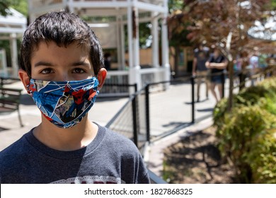 Albuquerque, New Mexico / USA - August 15, 2020 :  Young Boy In Mask At Albuquerque Bio Park Zoo With People In Background