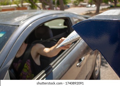 Albuquerque, New Mexico / USA - May 25 2020: Man Drops Off Mail Package With EBay Envelope From His Car At A USPS Mail Drop Box Outside The Post Office