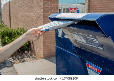 Albuquerque, New Mexico / USA - May 25 2020: Man Drops Off Mail Package With EBay Envelope At A USPS Mail Drop Box Outside The Post Office