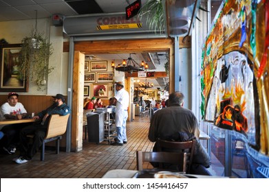 ALBUQUERQUE, NM / USA - DECEMBER 13 2010: Diners Eat While A Busboy Clears Tables In The Dining Rooms Of The 