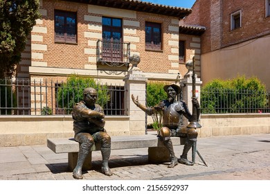 Alcala de Henares, Spain - May 13, 2022. Statue of Don Quixote and Sancho Panza facing the main facade of the Miguel de Cervantes House Museum. Alcala de Henares, Region of Madrid, Spain.