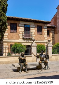 Alcala de Henares, Spain - May 13, 2022. Statue of Don Quixote and Sancho Panza facing the main facade of the Miguel de Cervantes House Museum. Alcala de Henares, Region of Madrid, Spain.