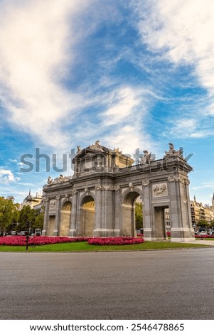 Alcala Gate with a sky full of clouds at dawn, photo with copyspace, Madrid, Spain