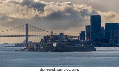 Alcatraz Island In The San Francisco Bay With The Bay Bridge In Backgrounded The City By The Bay 