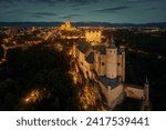 Alcazar of Segovia as the famous landmark aerial view at night in Spain.