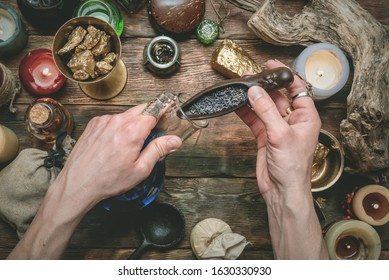 Alchemist producing gold from the stones on his magic table concept.