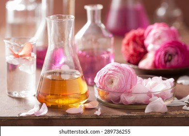 alchemy and aromatherapy set with ranunculus flowers and flasks