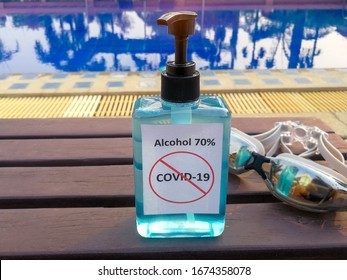 Alcohol 70% Sanitizer standing side of the swimming pool for protect corona virus or covid-19
