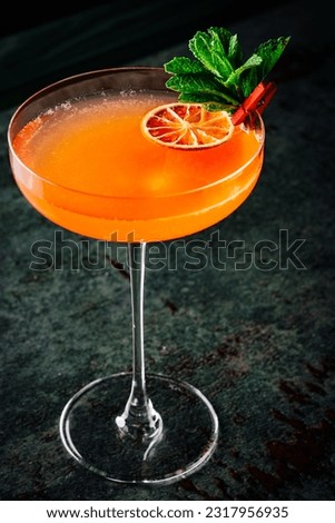 alcohol cocktail in a glass stands on a table in a bar or restaurant