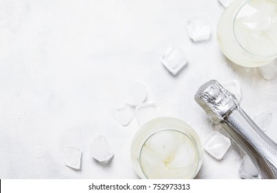 Alcohol Cocktail Prosecco On The Rocks With Sparkling Wine And Ice Cubes, Gray Background, Top View