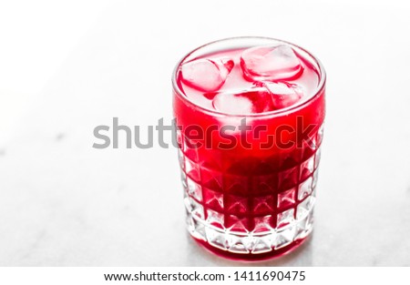 Alcohol drink, refreshment and cold beverage concept - Glass of red cocktail with ice, luxury bar party