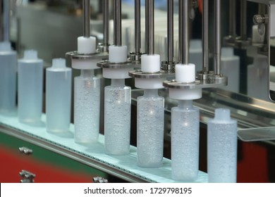 Alcohol Gel Bottles transfer on Conveyor Belt System of Gel filling machine in an industry. Alcohol Gel bottles produced against COVID-19 by industrail machine in a factory.