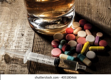Alcohol and pills on table with shadow