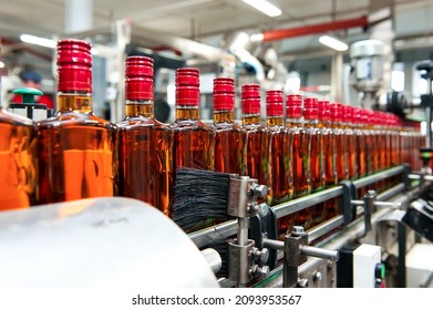 Alcohol production plant. Bottles of alcohol are in a row