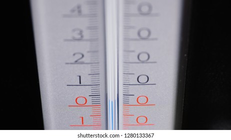 Alcohol thermometer on a black background, shows the temperature of the air slightly above zero degrees - Shutterstock ID 1280133367