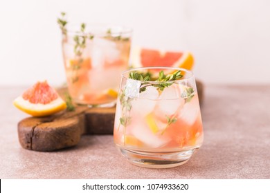 Alcoholic Cocktail Gin Bitter Lemon With Thyme And Grapefruit. Fruit Lemonade. Gray Slate Background. Horizontal View. Copy Space