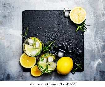 Alcoholic Cocktail With Lemon, Vodka, Soda, Ice And Rosemary, Grunge Stone Background, Top View