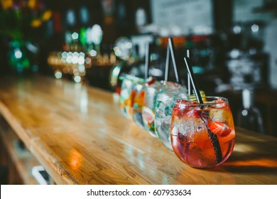 Alcoholic cocktail row on bar table, colorful party drinks  - Shutterstock ID 607933634