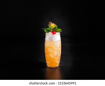 Alcoholic cocktail with yellow ice with green mint and berries. Dark background, copy space - Powered by Shutterstock