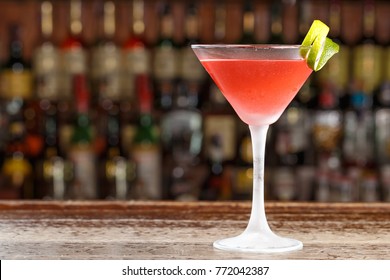 An alcoholic cosmopolitan cocktail is on the bar. Space for text. Photo for the menu