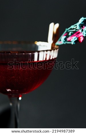 Alcoholic drink. A cocktail with elite alcohol on dark black background, close-up. Concept of  nightlife and exotic drinks.