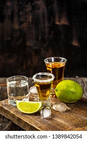 Alcoholic drink concept. Mexican tequila with lime and salt on rustic wood background. space for text. concept luxury drink.