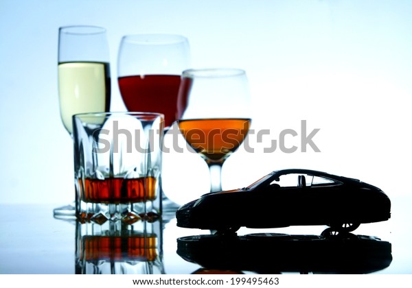 Alcoholic Drink and a toy car Photo of an\
alcoholic drink in a crystal glass and a toy\
car