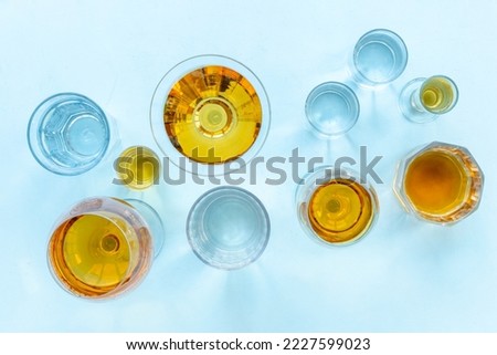 Alcoholic drinks in glasses with ice. Strong alcohol background