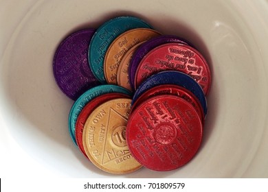 Alcoholics Anonymous Chips Displayed In A White Bowl