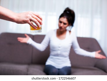 Alcoholism In Family, Sad Desperate Wife And Drunk Husband On Background, Alcohol Abuse At Home. Family Problem. Whiskey Glass. Stress. Depression. Depressed. Family Photo. Life. Drink. Concept. 
