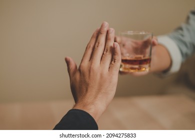 Alcoholism, Sad Depressed Asian Young Man Refuse, Push Alcoholic Beverage Glass, Drink Whiskey, Sitting Alone At Night. Treatment Of Alcohol Addiction, Having Suffer Abuse Problem Alcoholism Concept.