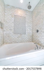 Alcove Bathtub With Marble Subway Tile Surround And Shower Head