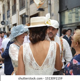 ALCOY, SPAIN - SEPTEMBER 21, 2019: Woman With Back To Camera Wearing Late 19th/early 20th Century Backless Lace Dress & Straw Skimmer Hat 
At Alcoy's 3rd Annual Modernist Fair Cultural Event.