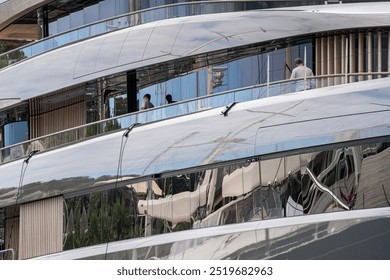  ale Caucasian Deckhands working doing a washdo in a large expedition style superyacht or megayacht at dock in Antigua during sailing season in th