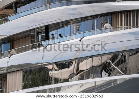  ale Caucasian Deckhands working doing a washdo in a large expedition style superyacht or megayacht at dock in Antigua during sailing season in th