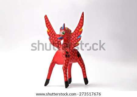 Alebrije of a flying red unicorn