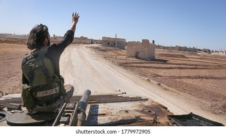 Aleppo, Syria 16 October 2016:
Syrian opposition fighters raise their hands of victory over the military vehicles after the victory over ISIS