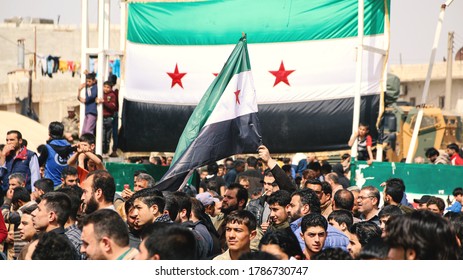 Aleppo, Syria October 18, 2018
A demonstration bearing the flags of the Syrian revolution calls for an end to the bombing of Idlib.