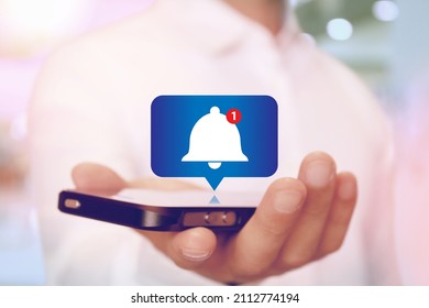 Alert Bell Notification on Smartphone on hand - Shutterstock ID 2112774194