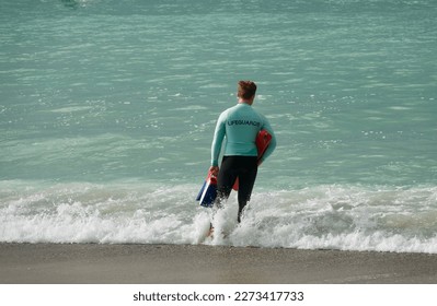 alert lifeguard with safety gear watching the coast - Powered by Shutterstock