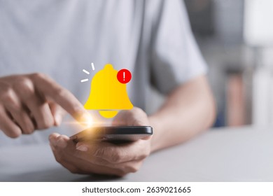 Alert notification concept. Mobile error or problem, Reminder, Push Notifications. Person using smartphone with bell notification icon on virtual screen.